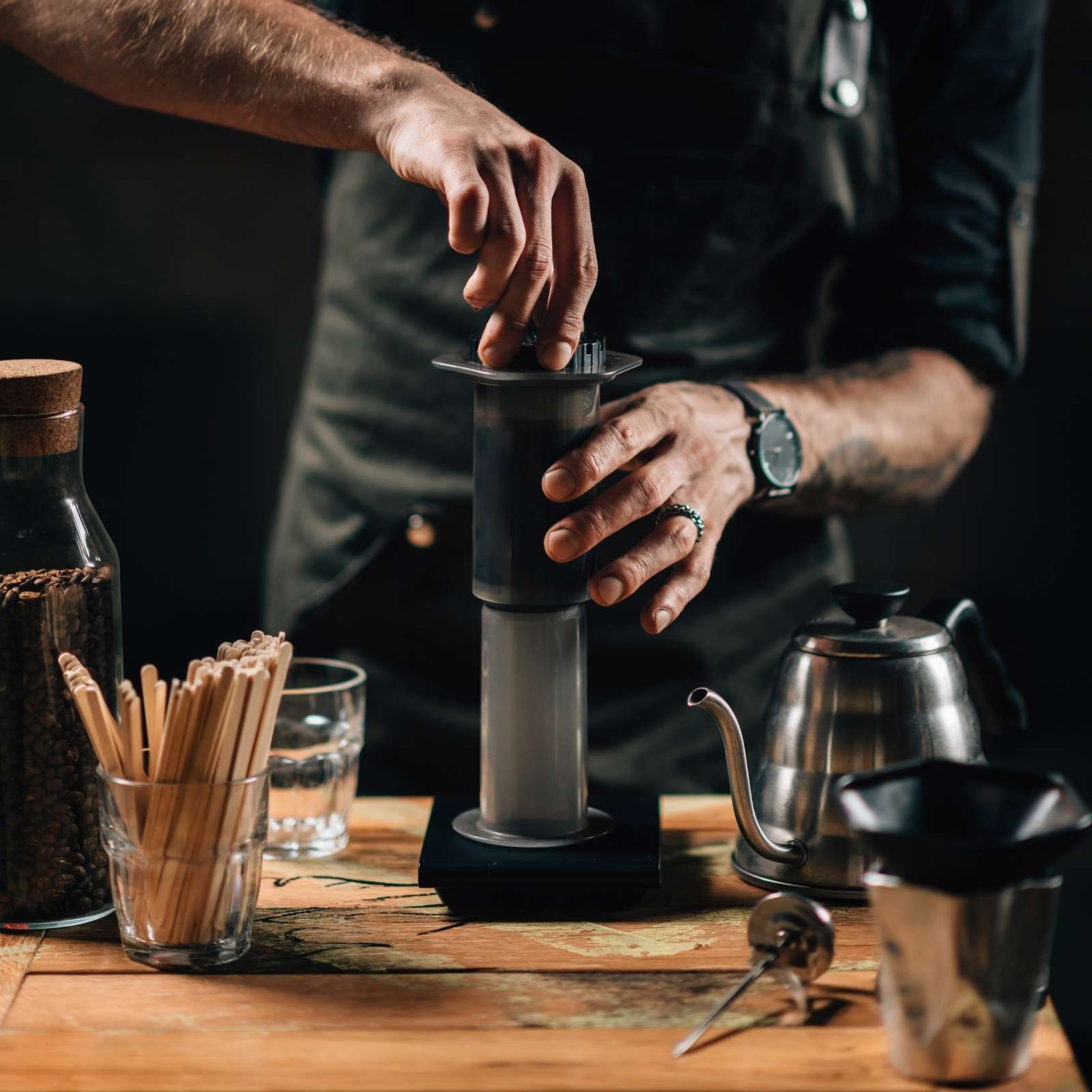 AeroPress coffee brewing method showing hot water being poured into the chamber before pressing