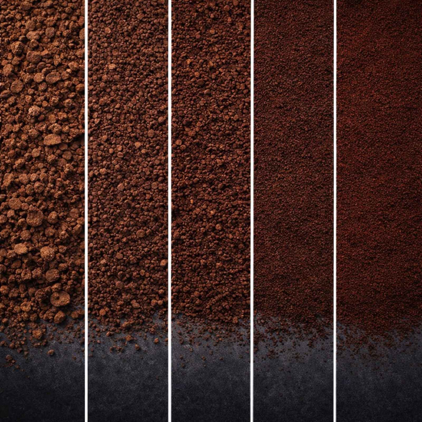Close-up of five vertical columns of coffee grounds showing progressively finer grind sizes, from coarse on the left to extra-fine on the right, arranged edge-to-edge on a dark charcoal surface.