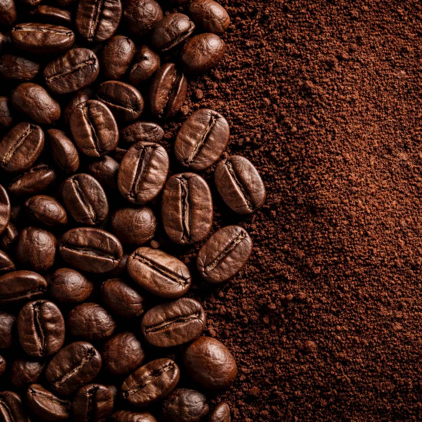 Close-up comparison of whole coffee beans and freshly ground coffee on a dark background, illustrating increased surface area after grinding and its impact on flavor freshness.